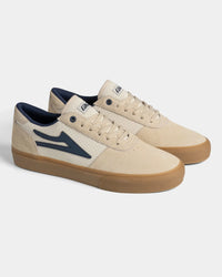 Lakai Manchester Elite skate shoes in Whisper White Suede Navy, angled pair view
