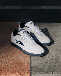 Skater wearing Lakai Cambridge XLK skate shoes in White Suede Navy Gum