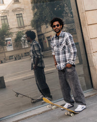 Skater wearing Lakai Cambridge XLK skate shoes in White Suede Navy Gum