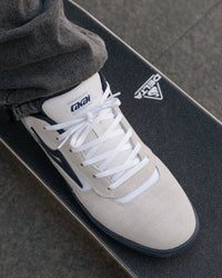 Skater wearing Lakai Cambridge XLK skate shoes in White Suede Navy Gum