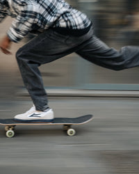 Skater wearing Lakai Cambridge XLK skate shoes in White Suede Navy Gum