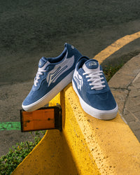 Skater wearing Lakai Essex skate shoes in Light Navy Suede White