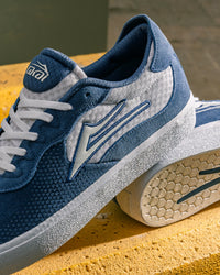 Skater wearing Lakai Essex skate shoes in Light Navy Suede White