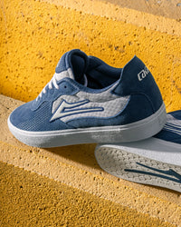 Skater wearing Lakai Essex skate shoes in Light Navy Suede White