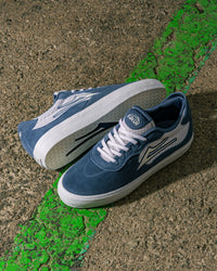 Skater wearing Lakai Essex skate shoes in Light Navy Suede White