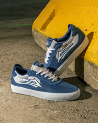 Skater wearing Lakai Essex skate shoes in Light Navy Suede White