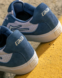 Skater wearing Lakai Essex skate shoes in Light Navy Suede White