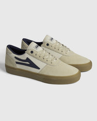 Lakai Manchester Elite skate shoes in Whisper White Suede Navy, angled pair view